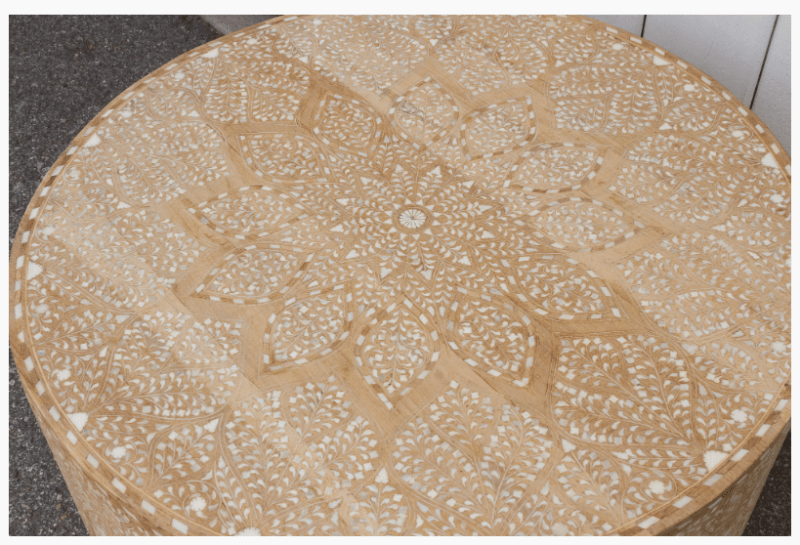 Top-down view of round bone inlay coffee table surface showing Moroccan star mandala floral inlay pattern, handcrafted natural wood artisan furniture
