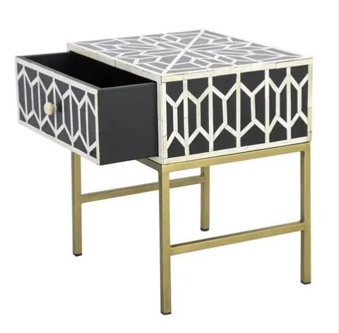 Black and white bone inlay one-drawer nightstand with open drawer showing interior storage, all-over geometric trellis inlay on top and sides, gold metal base.