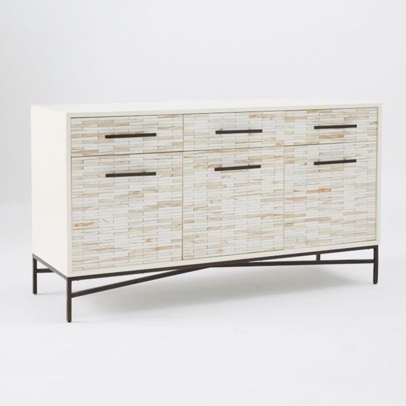 Bone inlay tiled buffet cabinet with cream and off-white natural inlay on three drawers and two doors over an iron cross-base frame on white background