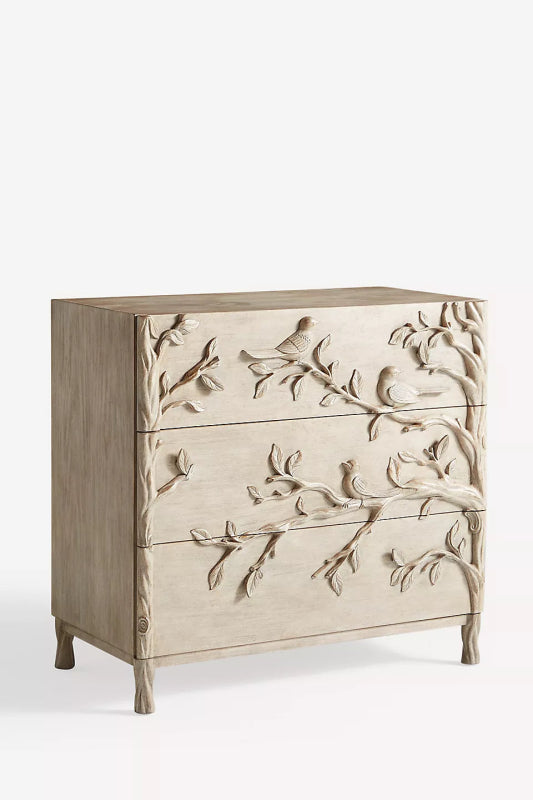 Washed-grey wood bureau with a botanical relief of perched birds and branches across its drawer faces.