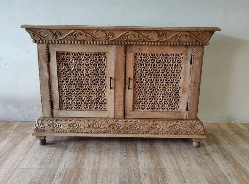Carved wood storage cabinet in rustic solid wood, front view showing two lattice doors and floral carved top and base.