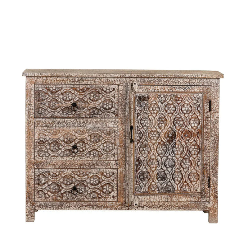 Distressed carved cabinet in a front view, showing three stacked drawers beside a cabinet door with floral panels.