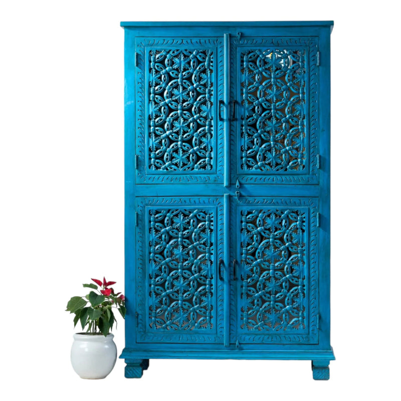 Floral lattice wood cupboard in distressed teal, front view showing four carved doors, paired handles and short feet.