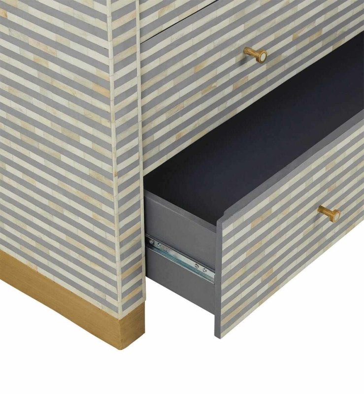Open drawer detail of a grey striped bone inlay waterfall dresser showing smooth glide mechanism, gold pull hardware, and spacious interior storage compartment.