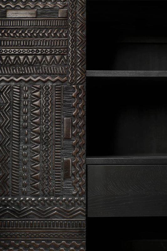 Hand-carved two-door cupboard in a detail view.