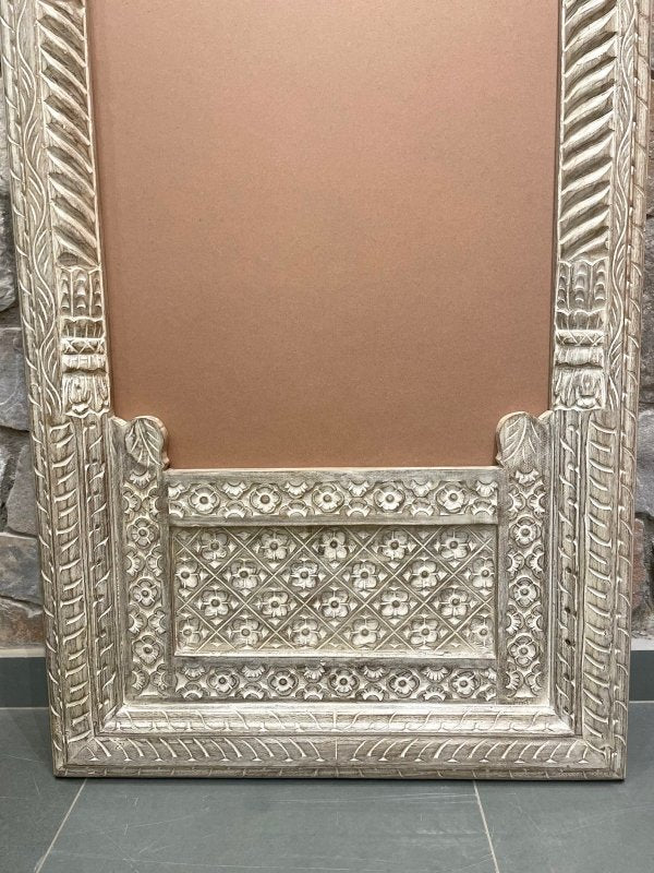 Jharokha arch standing mirror in distressed solid wood, base detail view showing floral lattice and carved trim.
