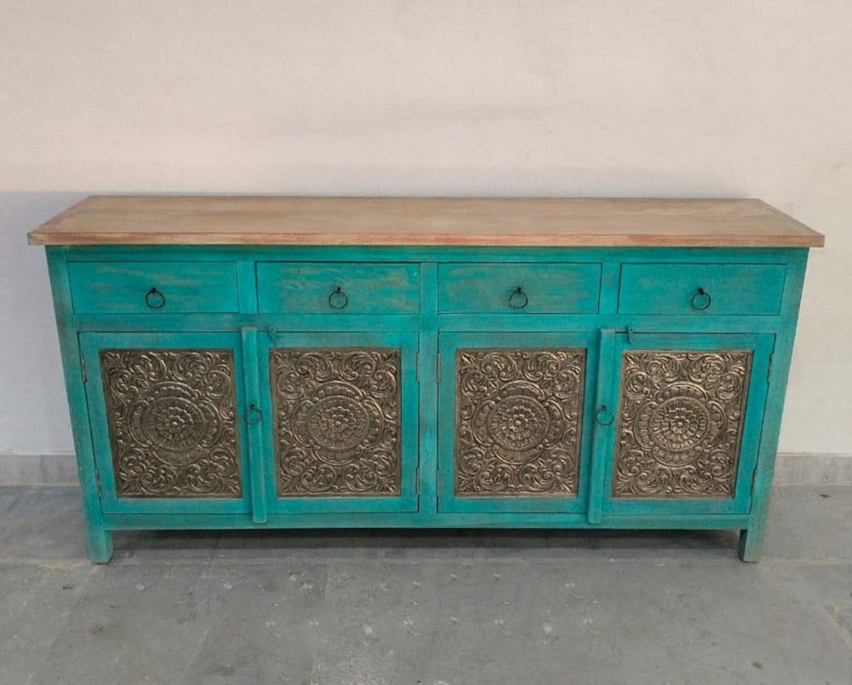 Framed panel cabinet in teal with four patterned doors, shown in a front view against a plain light wall.