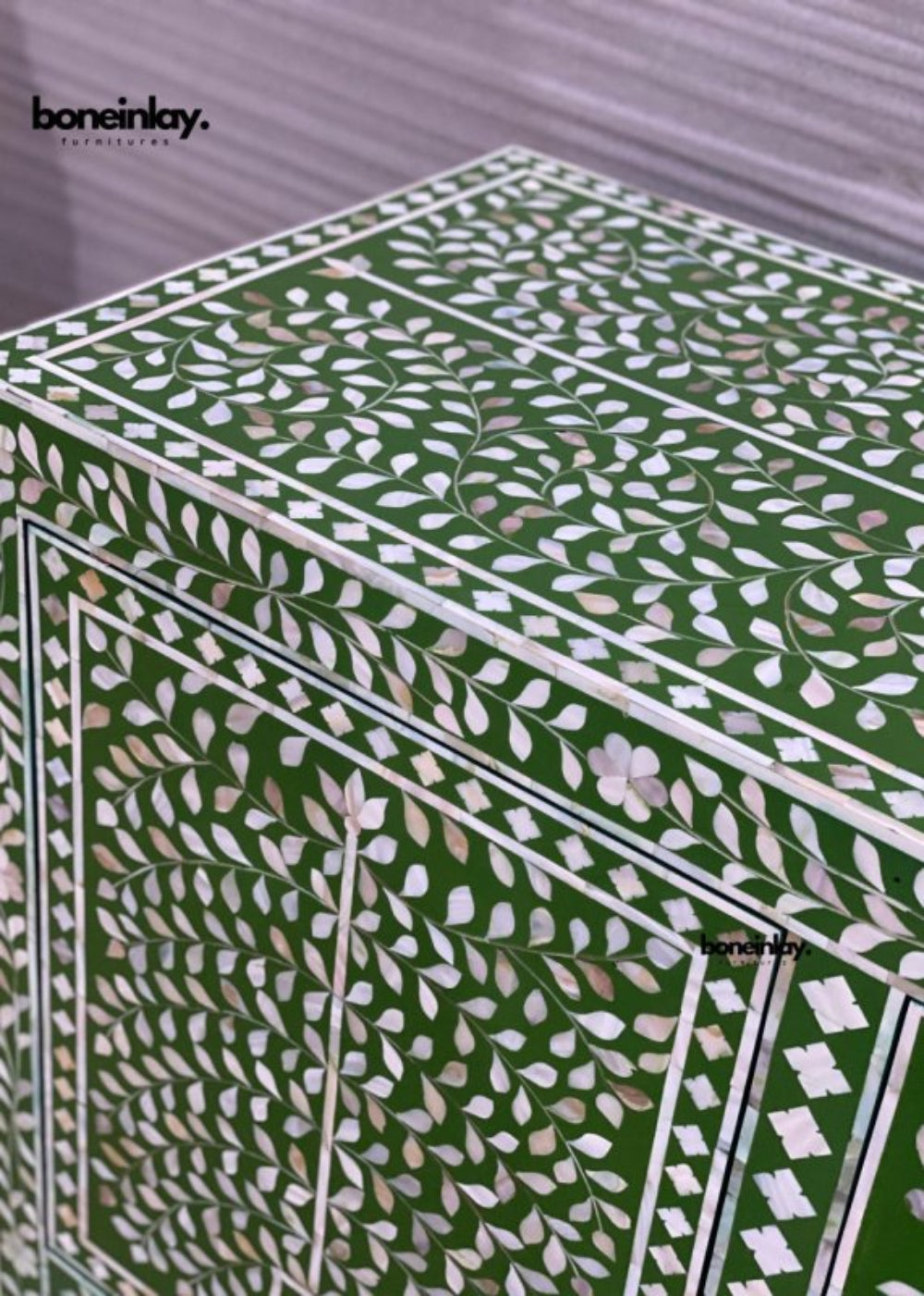 Close-up of green mother of pearl floral leaf pattern on credenza cabinet surface showing handcrafted shell tile work