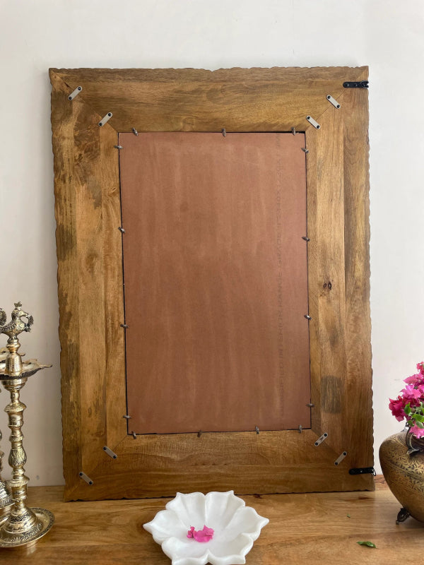 Rectangular solid wood mirror, back view showing a brown backing panel, retaining clips and metal mounting fittings.