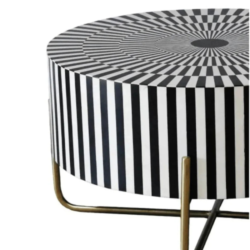Luxury round bone inlay coffee table with an optical illusion striped inlay surface in black and white, featuring an antique brass cross-leg metal base