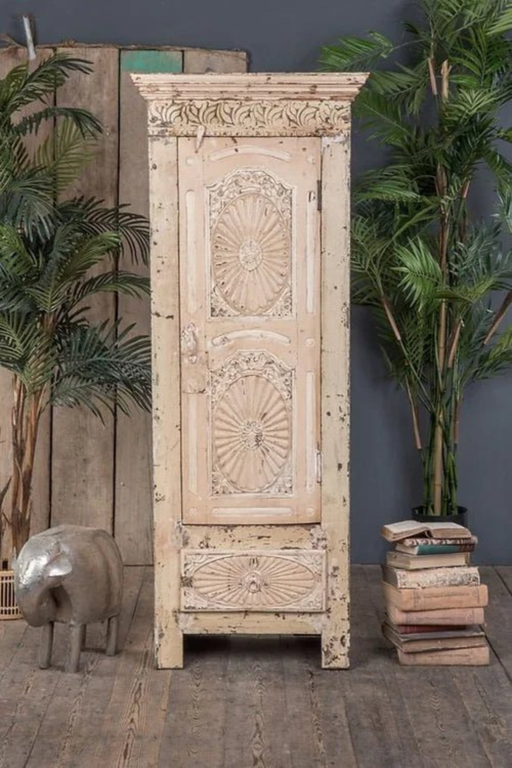 Rustic white linen cabinet with bottom drawer, side profile view highlighting door panel depth.
