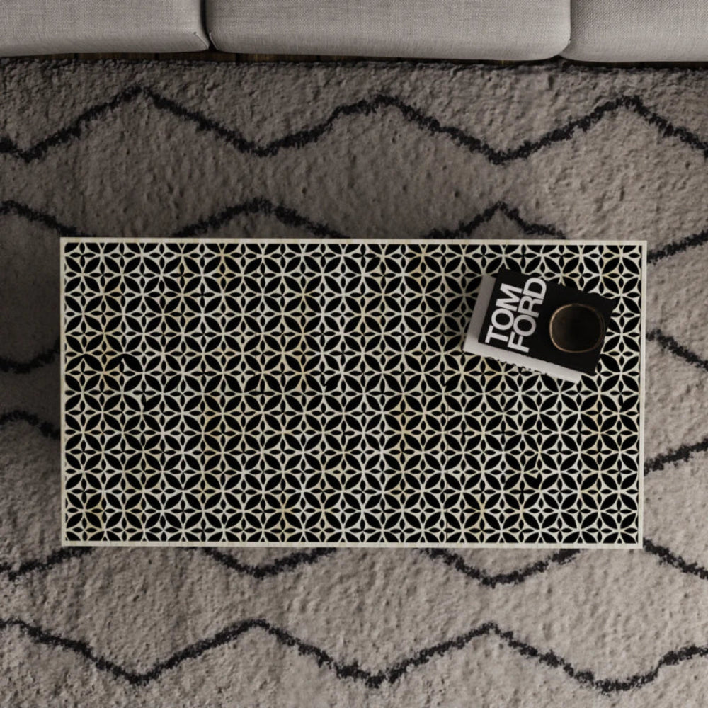 Overhead view of stellar monochrome bone inlay coffee table displaying full black and white geometric star-cross inlay pattern across the surface.