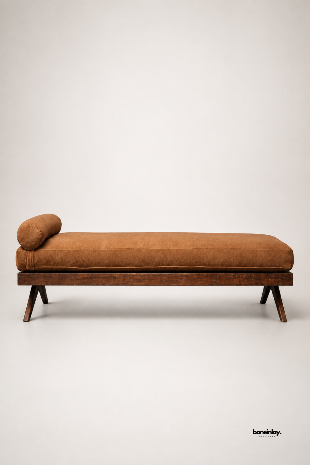 Artisan-crafted brown upholstered wooden daybed presented against a clean neutral background, highlighting its rich dark wood platform base, sturdy angled legs, and comfortable bolster cushion. This minimalist lounge bench delivers exceptional relaxation and timeless style for modern British living spaces.