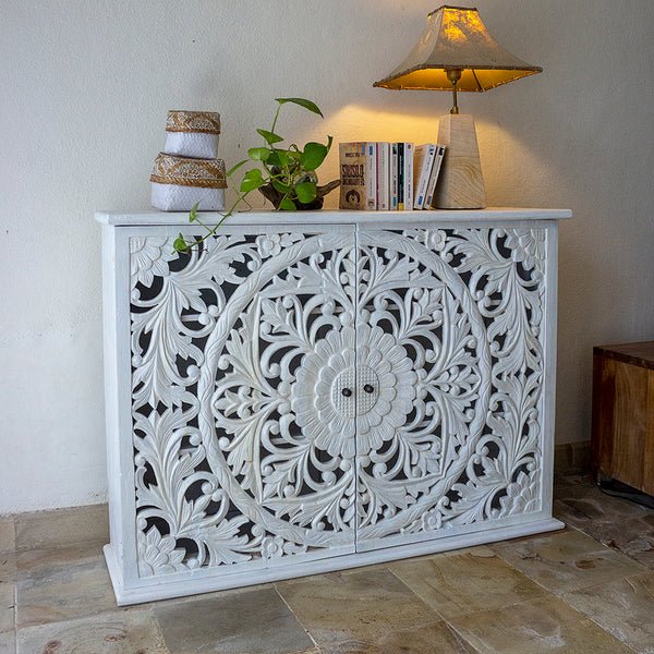 Vintage Blossom Wooden Credenza in rustic, styled in a living room with a trailing plant, books, jars and a table lamp.