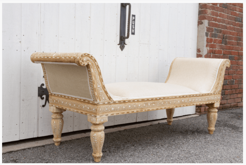 Traditional wood inlay teak chaise lounge from back angle showing upholstered back panel and turned legs