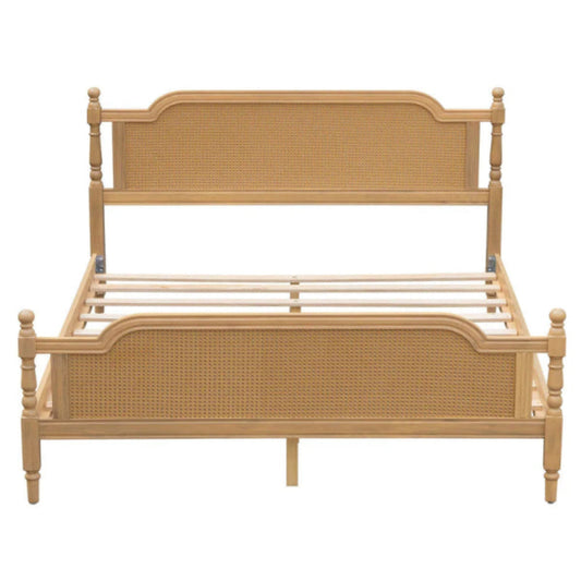Woven rattan bed frame in front view, showing tall headboard, lower footboard, curved upper rails and slender posts.