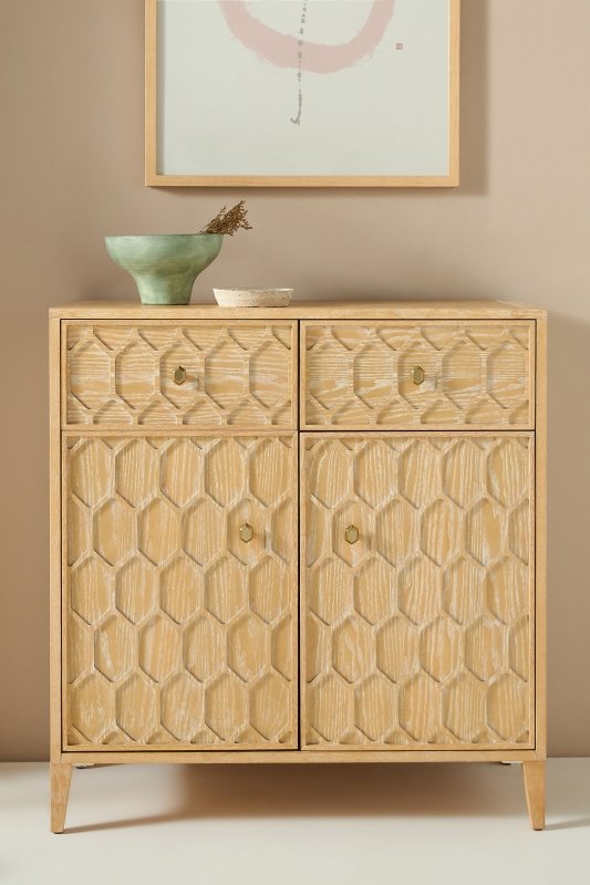 Textured Trellis storage cabinet in a natural wood finish, featuring two drawers and two doors with a raised honeycomb-inspired geometric pattern and minimalist hardware.