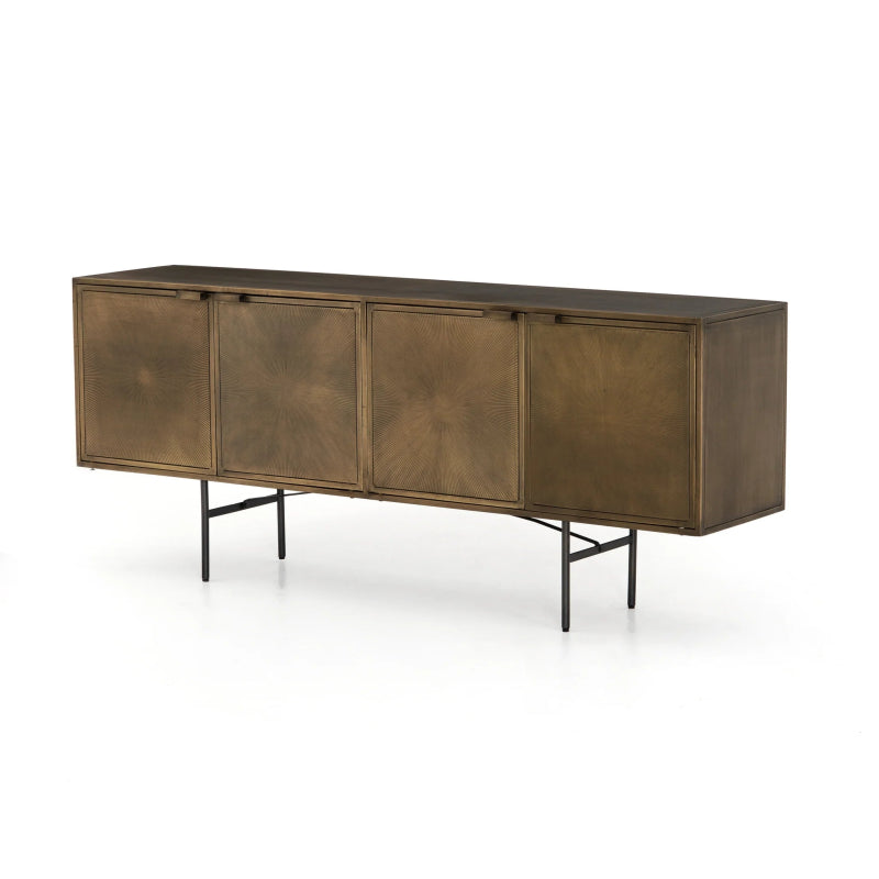 Long four-door sideboard credenza wrapped in an aged brass finish with fine etched sunburst patterns on a slender dark gunmetal metal frame base.