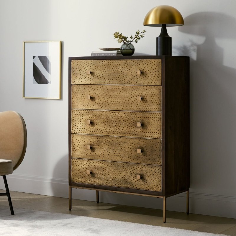 Golden brass dresser with five drawers, textured metal cladding, and decorative brass-finish knobs.