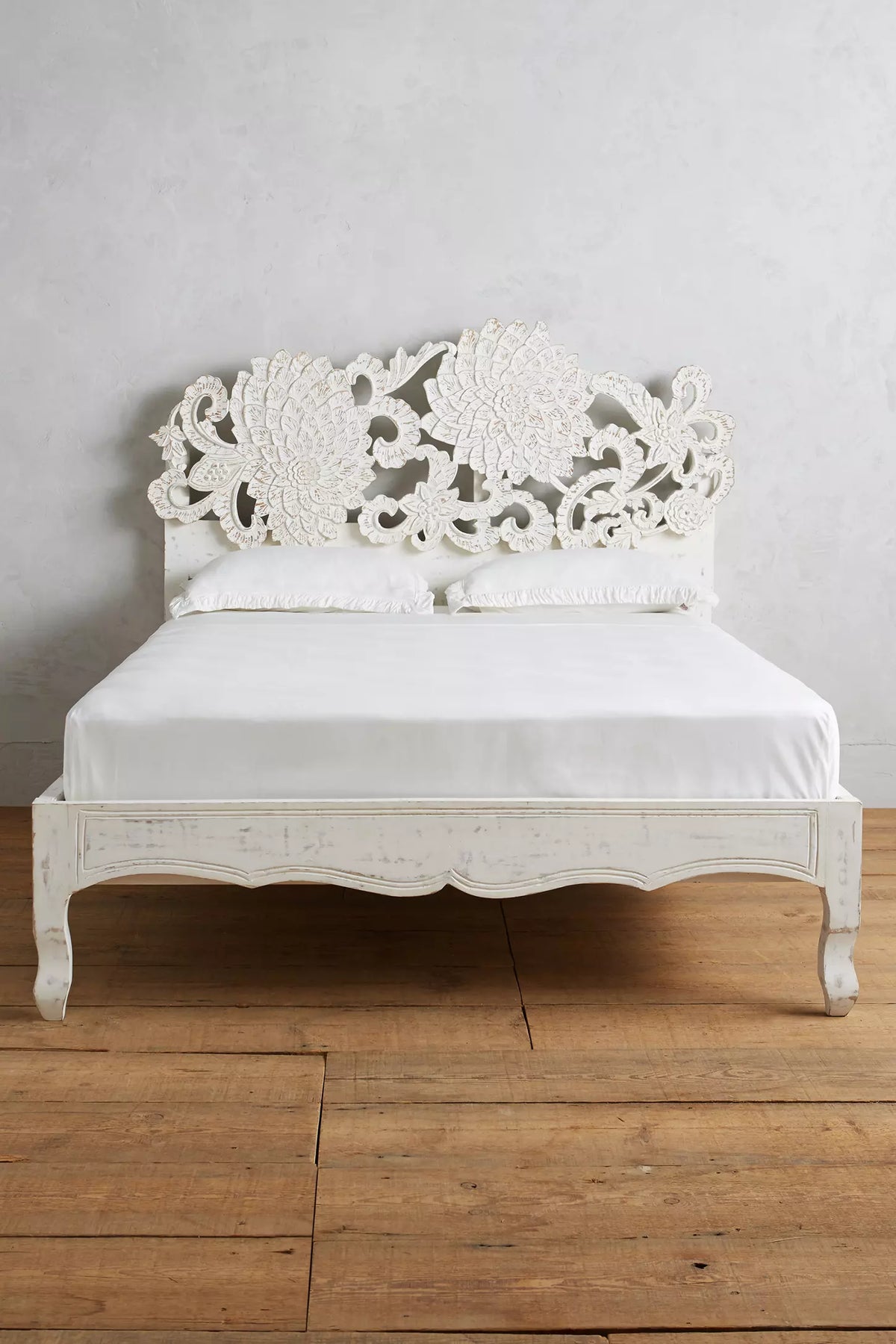 Whitewash lotus-carved platform bed with scalloped footboard and detailed carved wood legs.