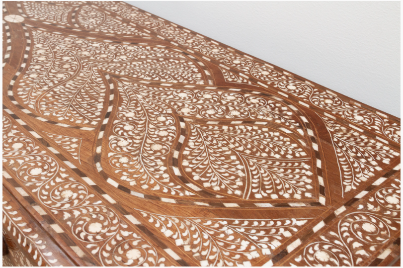 Close-up of the wood inlay dresser top showing delicate floral vines, leaf motifs, and geometric borders.