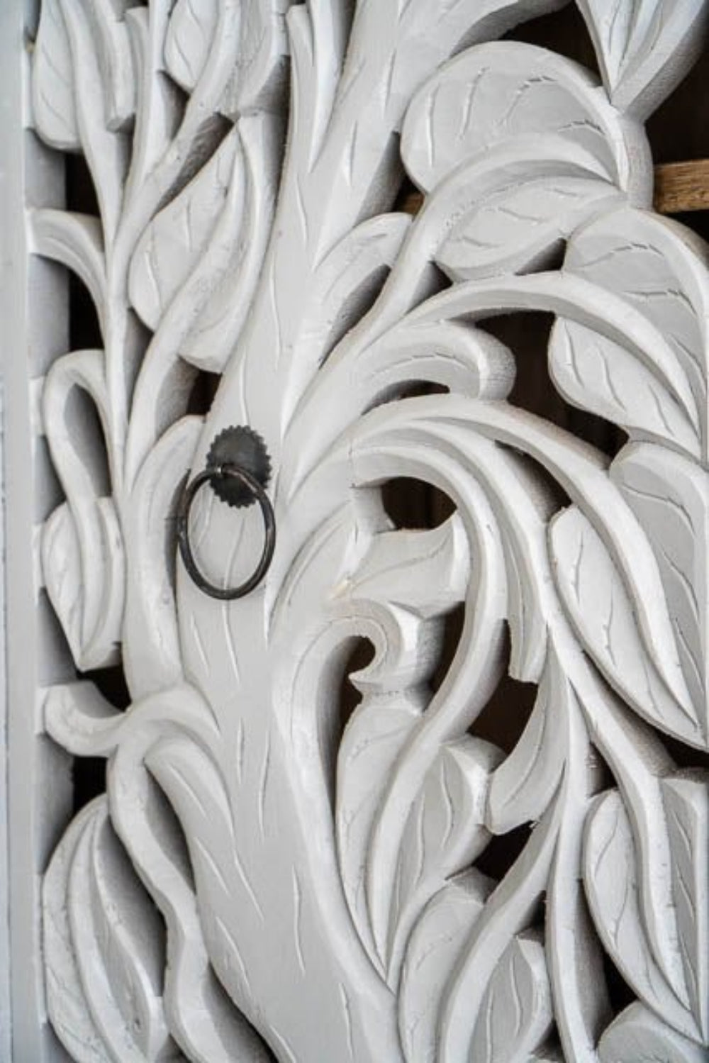 Elephant Storage Cabinet close-up showing its white finish, carved jungle-elephant panels, and detailed twin-door surface.