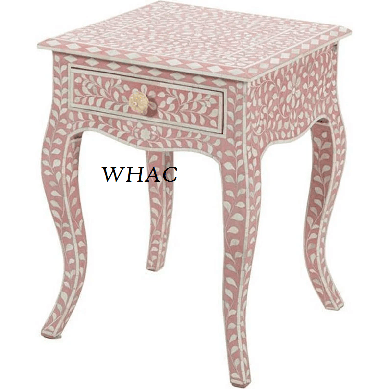 Handcrafted pink bone inlay bedside table featuring all-over leaf vine inlay, single drawer with floral knob, and elegant curved legs on white background