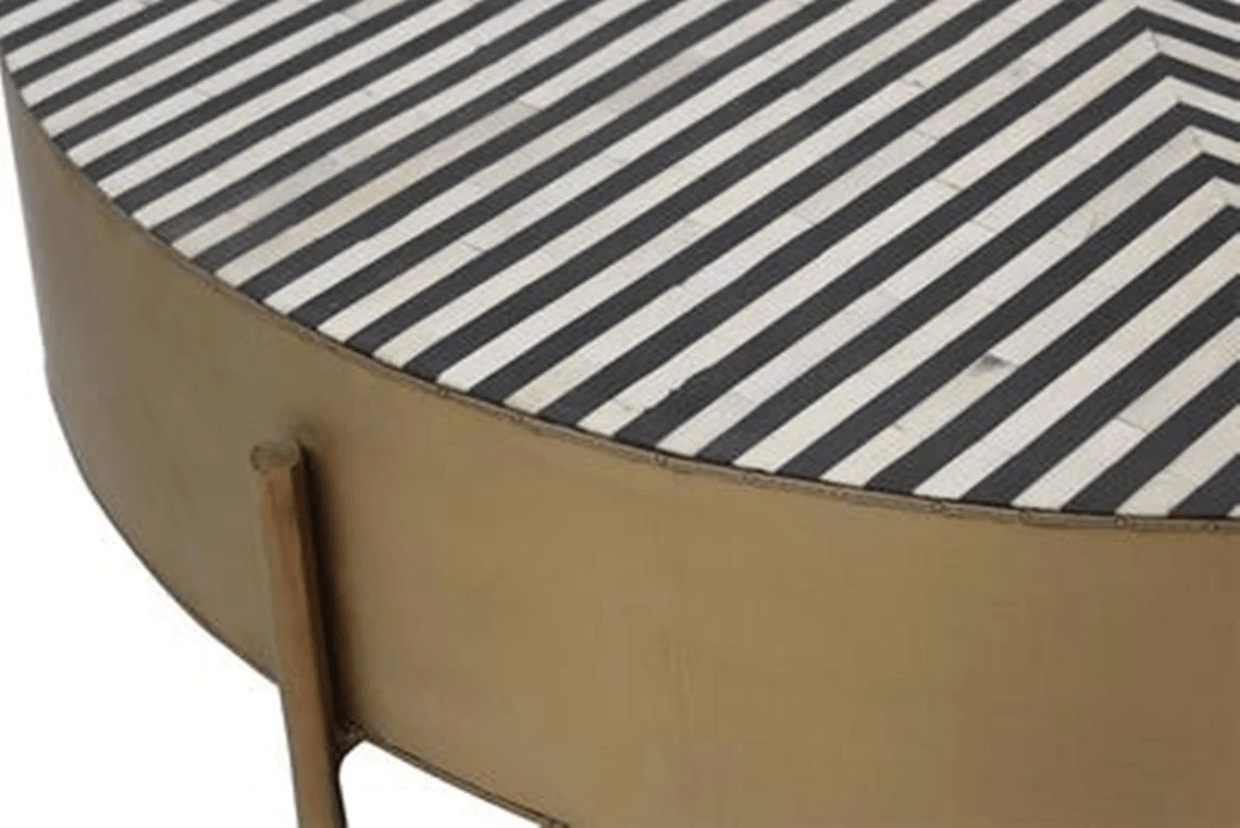 Detailed view of handmade monochrome black and white stripe bone inlay tabletop with fine inlay craftsmanship and antique gold iron cylindrical frame base
