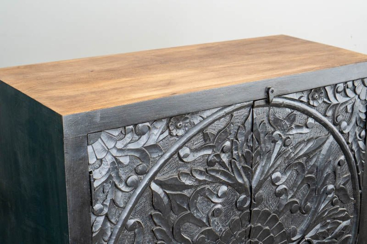 Natural Top Carved Sideboard in charcoal wood, shown in corner detail view with a contrasting wood top and floral relief.