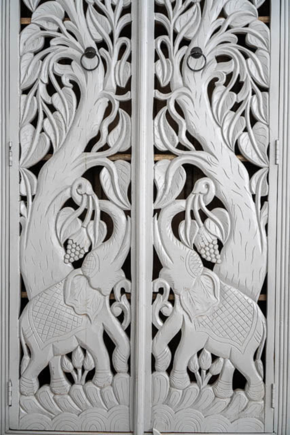 White Arched Cupboard shown from a slightly angled front view, with closed doors and decorative jungle panels.