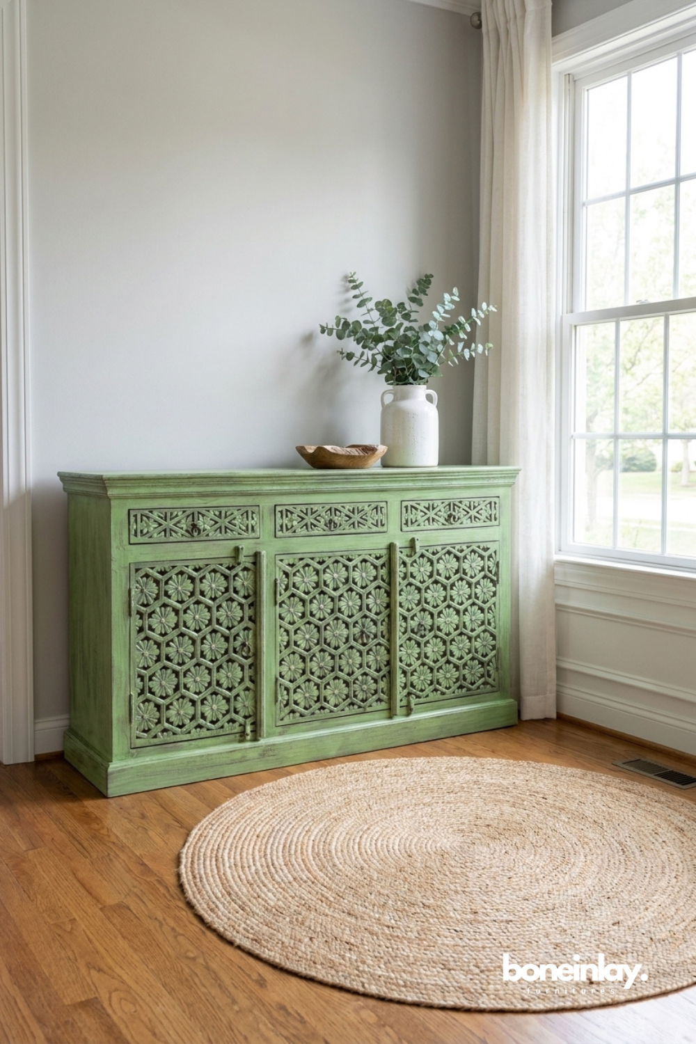 Elegant green storage cabinet featuring geometric floral lattice carvings and a soft antique patina.