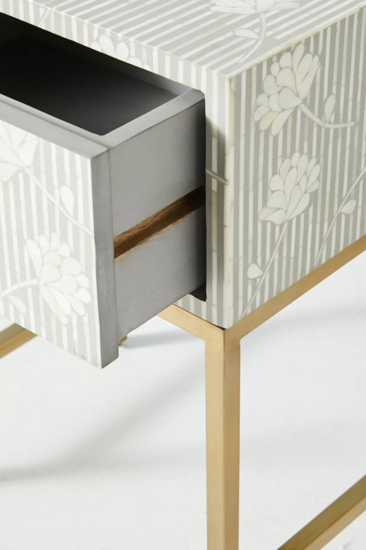 Ada bone inlay nightstand with drawer pulled open showing interior grey storage compartment, floral stripe mosaic on all sides and top, mango wood body, and gold metal legs.
