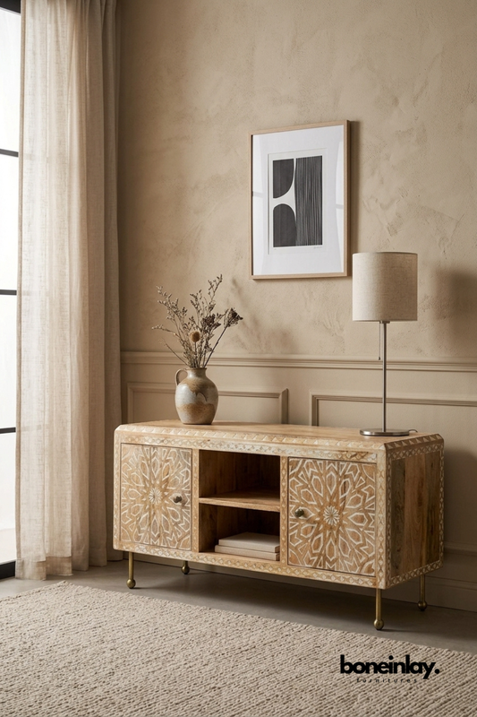 Natural wood Media TV Unit with a hand-carved mandala star pattern.
Two carved doors flank an open center shelf for display or storage.
Whitewashed detailing highlights the intricate geometric carving.
Raised on slim brass metal legs for a modern boho look.