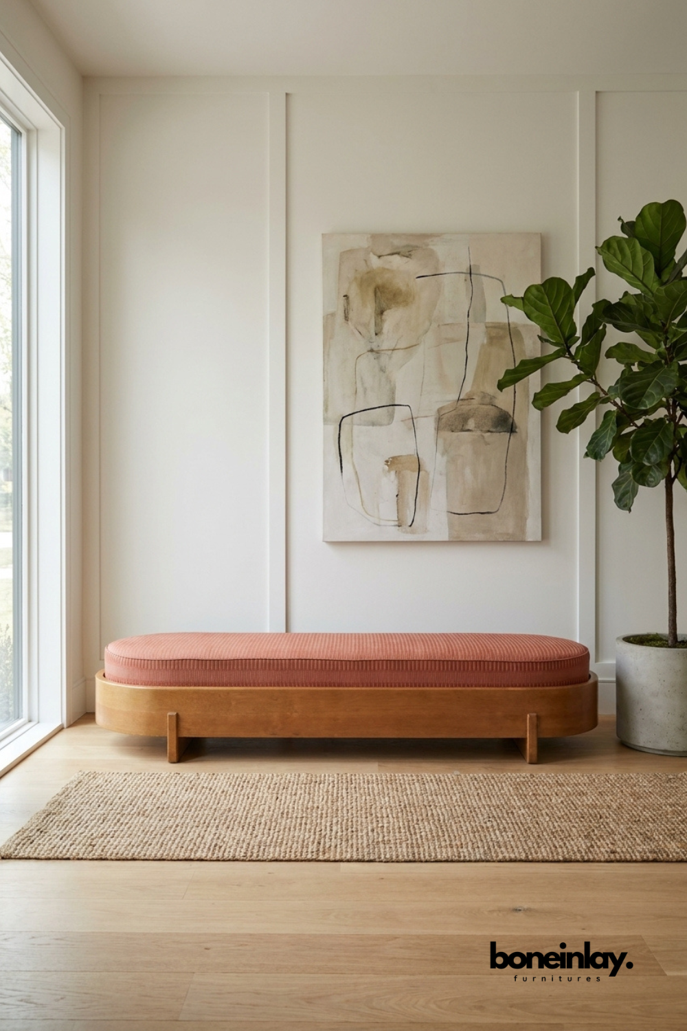 Minimalist oval-shaped bench with terracotta pink upholstered cushion and light oak wood base