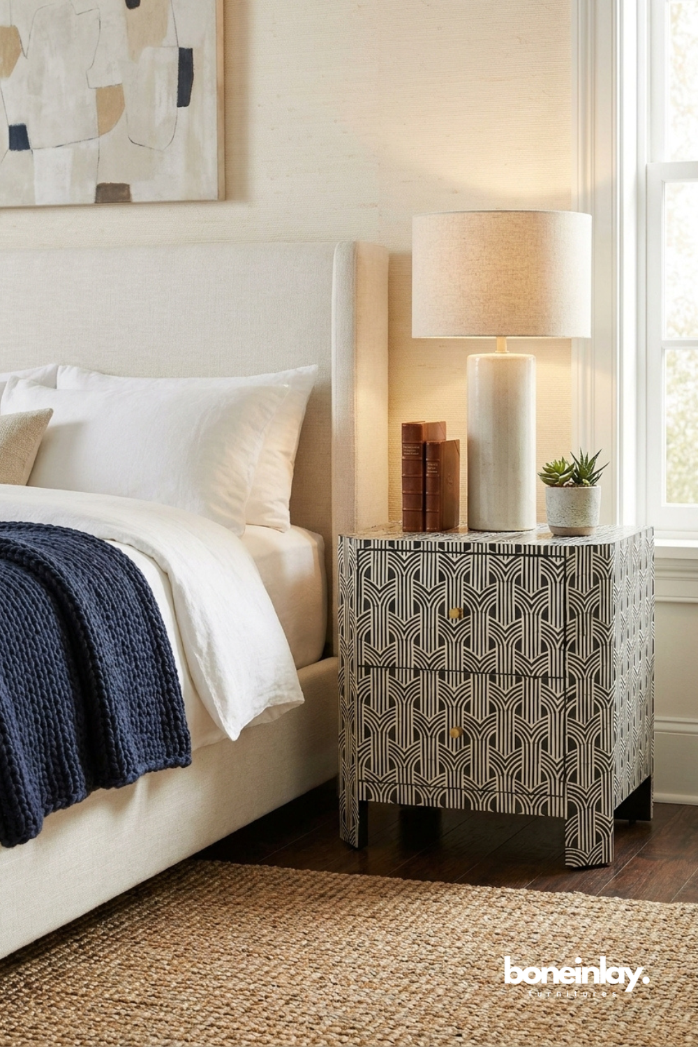 Art Deco Bone Inlay Black and White Nightstand in a front three-quarter bedroom view with two drawers
