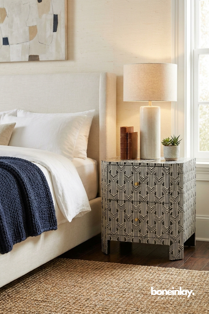 Art Deco Bone Inlay Black and White Nightstand in a front three-quarter bedroom view with two drawers