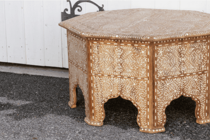 Close-up of bone inlay coffee table showing intricate floral inlay on side panels and Moorish arch carved legs with fine teak wood craftsmanship.