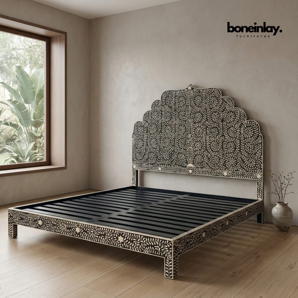 Black and white floral bone inlay bed frame with scalloped arched headboard and intricate vine motif, shown without mattress