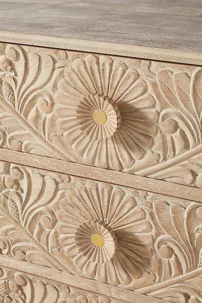 Close-up of the beige Gulliver drawer chest, showing the carved texture and finish on its front surface.