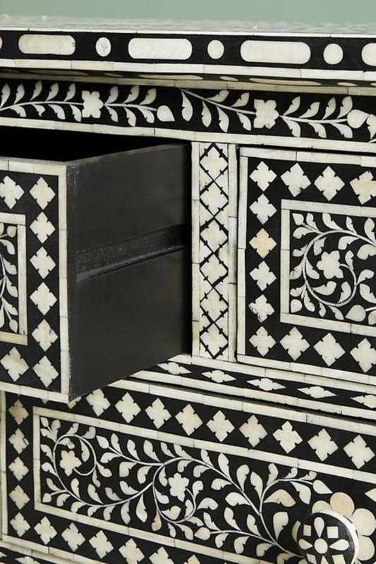Close-up of open drawer on black bone inlay seven-drawer dresser revealing deep storage interior and surrounding floral inlay border detail