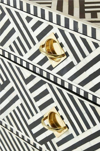 Black Bone Bureau with white geometric inlay, shown in a close-up of the drawer fronts and brass pulls.