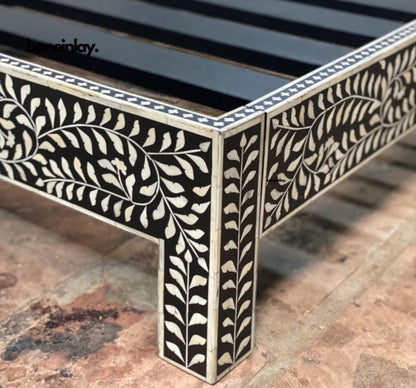 Corner detail of Black Bone Inlay Bed Frame showing hand-carved floral leaf pattern on platform base and legs with white inlay on black wood – Indian Artisan Furniture