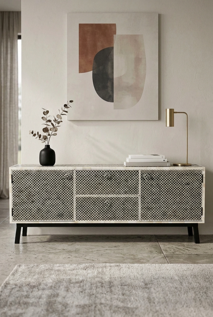 Black Bone Inlay Media Console, front view with patterned sections, closed doors, drawers and black legs in a styled room