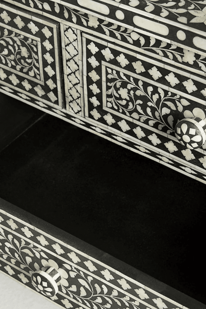 Angled close-up of open drawer on black bone inlay dresser highlighting bone knob and geometric diamond inlay pattern on drawer front