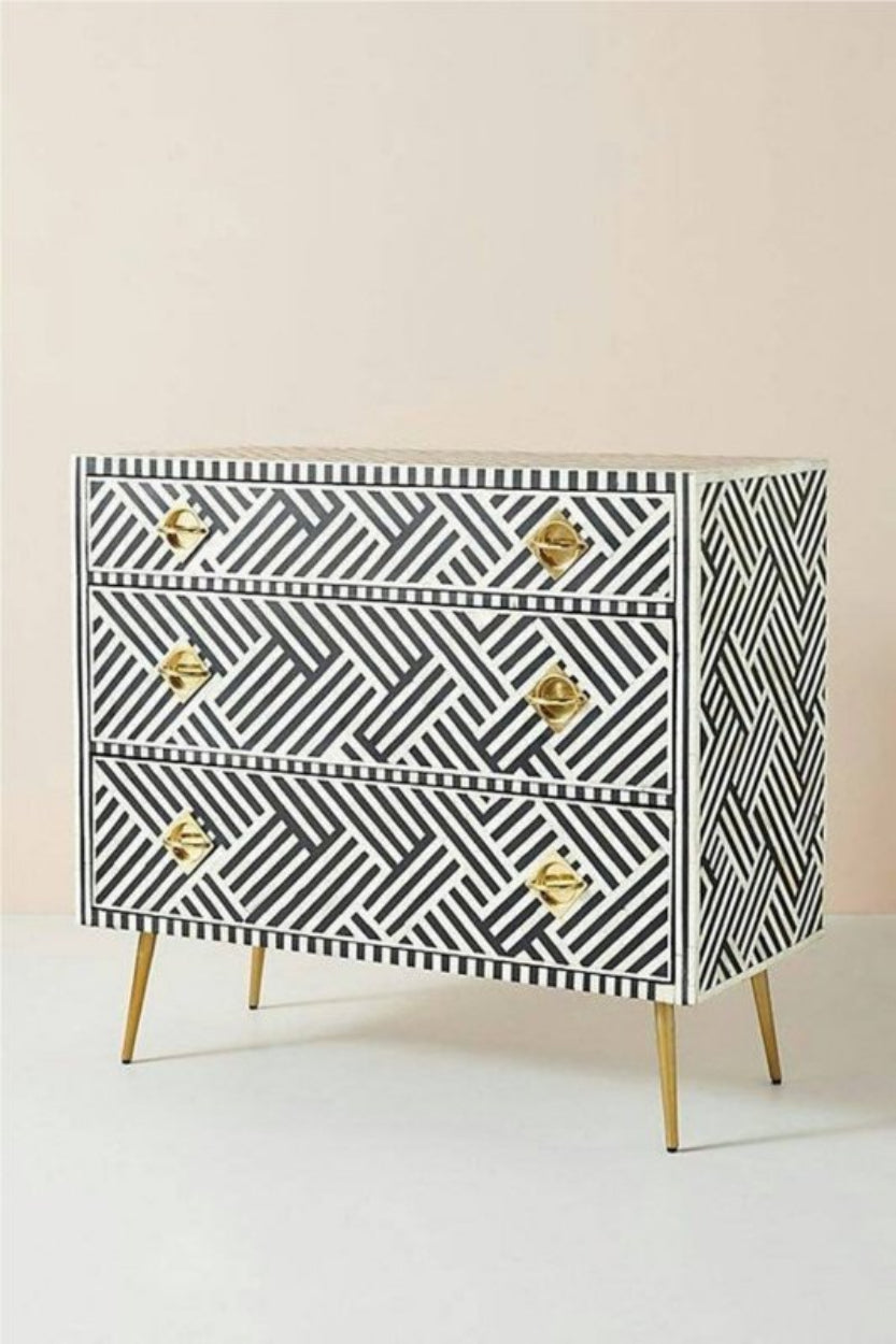 Black Optical Dresser with white bone inlay, shown from the front-right angle with three drawers and brass legs.