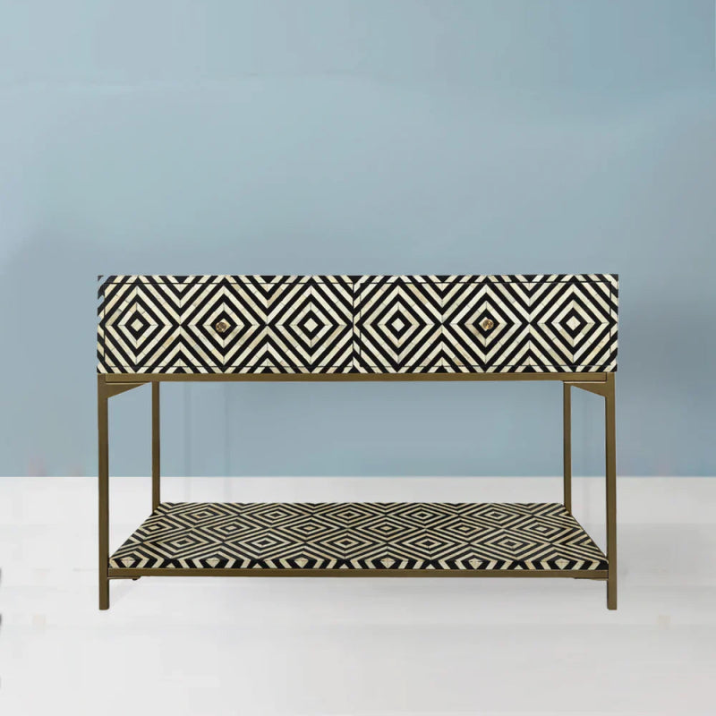 Black and white geometric bone inlay console table with two drawers and open display shelf on a gold brass metal frame, handmade luxury furniture