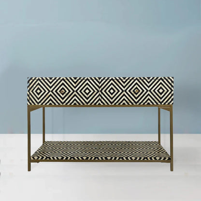 Black and white geometric bone inlay console table with two drawers and open display shelf on a gold brass metal frame, handmade luxury furniture