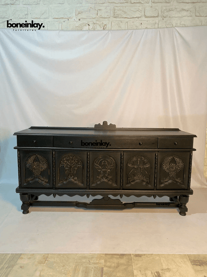 Black Wildlife Storage Credenza in wood, front view with carved animal doors and upper drawers against a fabric backdrop.