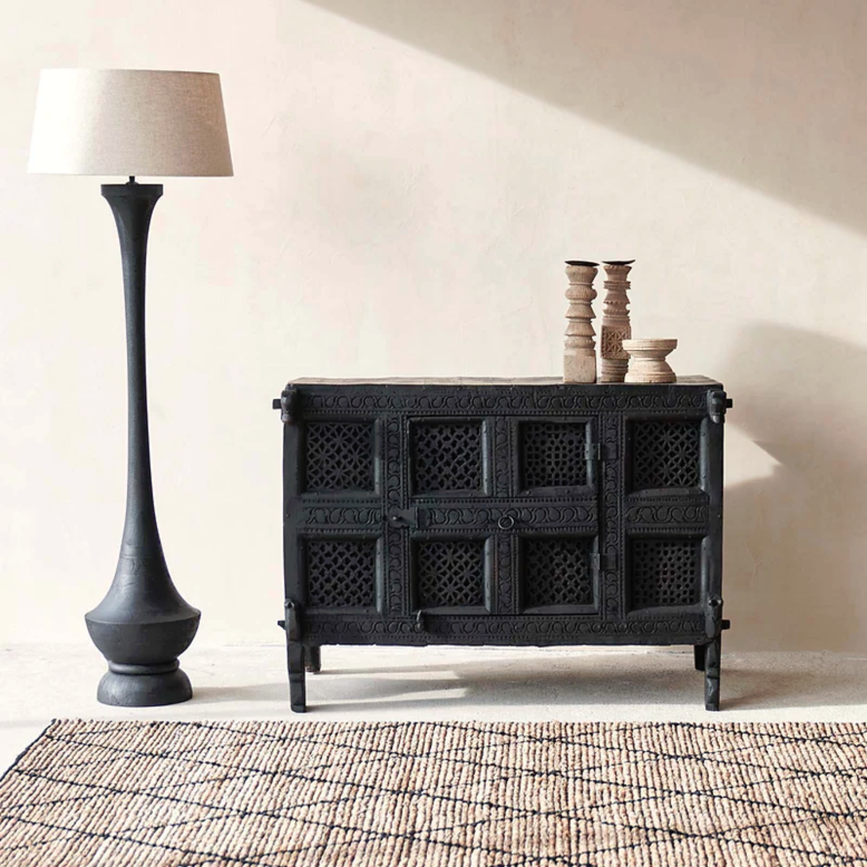 Hand-carved solid wood Indian Damchiya cabinet with Jali lattice panels and iron hardware in distressed matte black finish.