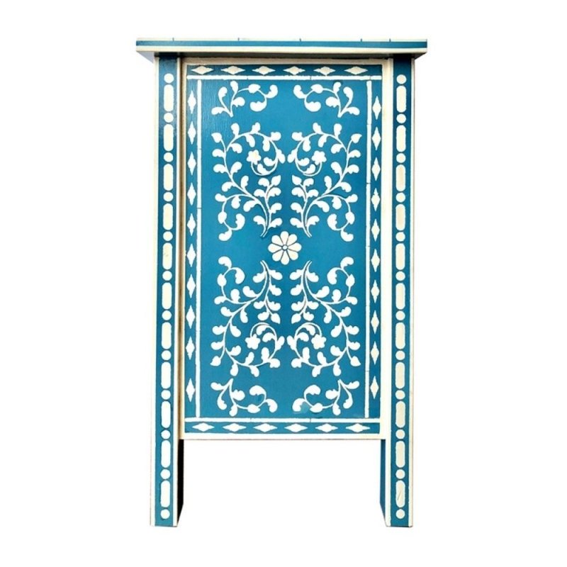 Teal blue bone inlay nightstand side surface showing white floral vine medallion center, diamond border row, quatrefoil corner details, and two-drawer front with ceramic knobs.